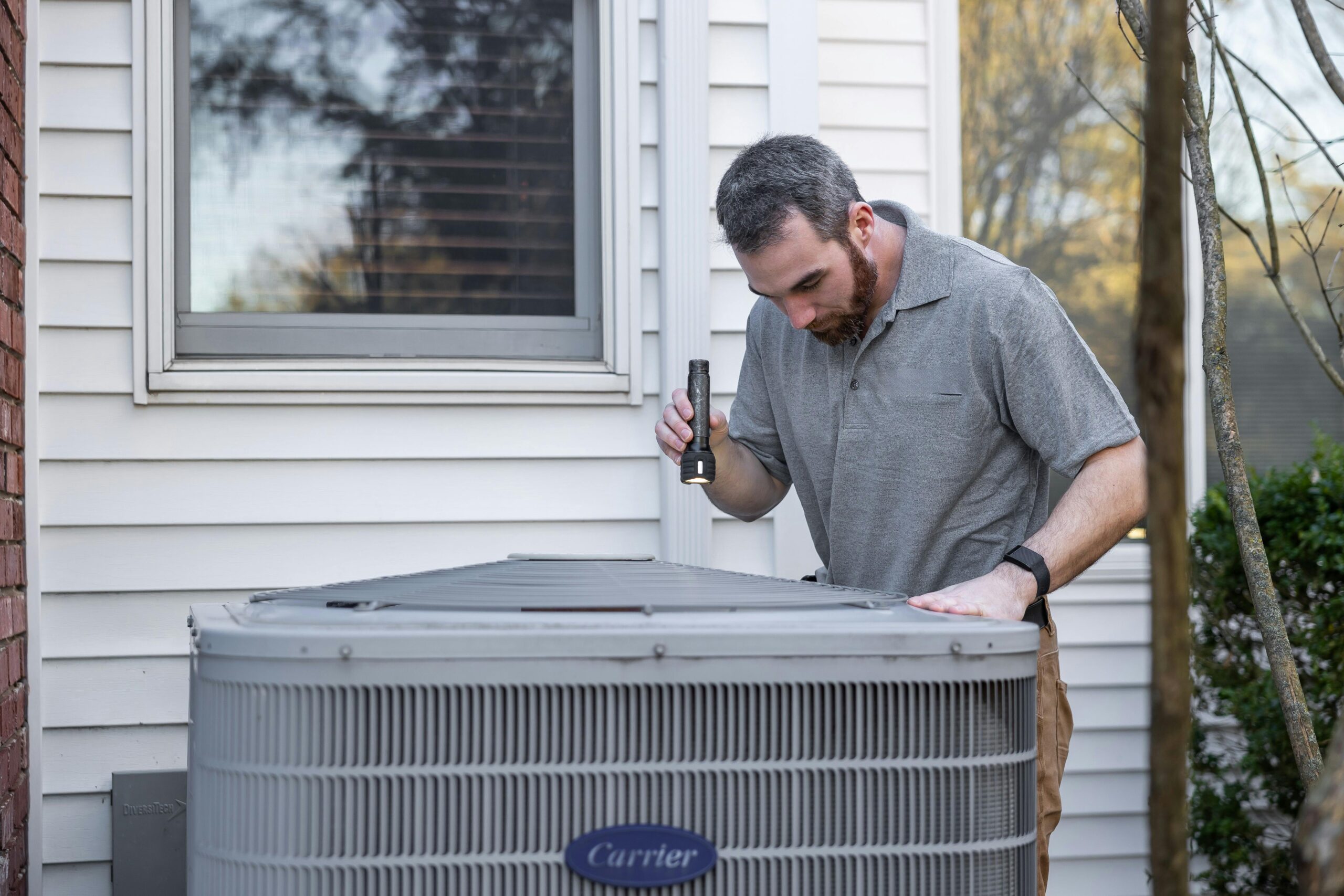 Element Air technician inspecting an outdoor HVAC unit